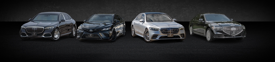 A lineup of four luxury cars displayed against a dark background.