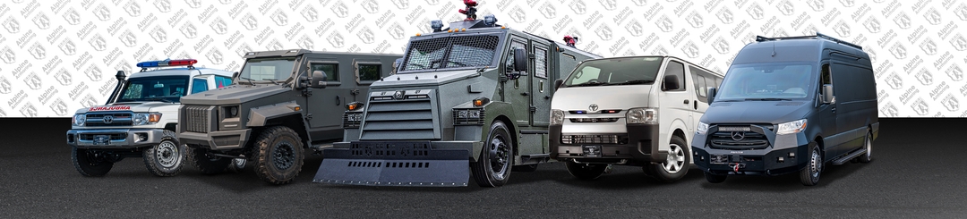  A lineup of five armored vehicles from Alpine Armoring is displayed in front of a patterned background. The vehicles vary in size and design, ranging from smaller vans to larger, heavily armored trucks with lights and sirens on top.