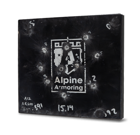 A black armored steel panel labeled "Alpine Armoring" with multiple bullet impact marks and test data written on it.