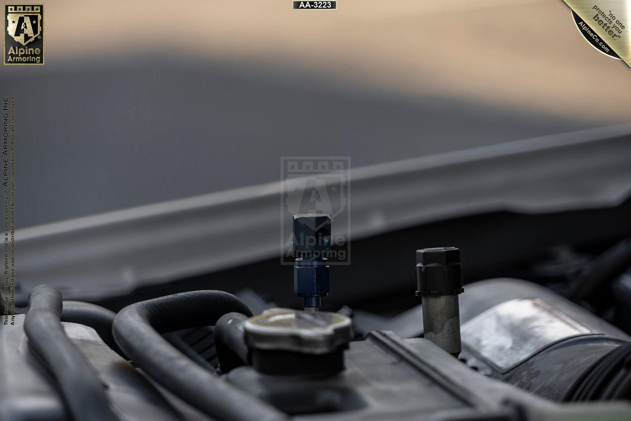 Close-up image of a Mastiff engine bay focusing on various components and wiring. The background is blurred, and an Alpine logo is visible in the top left corner.