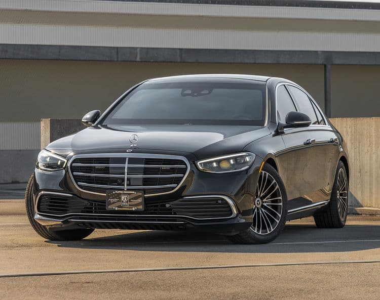 A black armored Mercedes-Benz S580 Executive sedan is parked on an empty rooftop parking lot. The car is viewed from the front-left angle.