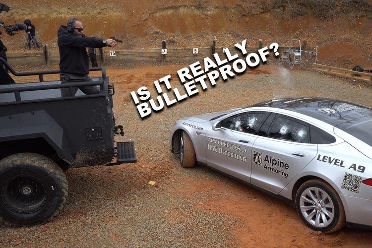  A person is firing a handgun at the side of a bulletproof Tesla labeled "Alpine Armoring" during a test. The car's windows and doors show bullet marks. Text reads, "IS IT REALLY BULLETPROOF?"