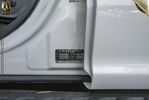 Close-up image of a label on the frame of a Mastiff door, showing specifications for a "Mastiff" model. The text includes manufacturing information and a reference to "Alpine Armoring Inc.