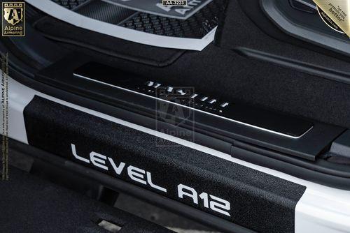 Close-up of a Mastiff door sill with "LEVEL A12" and "VITAL ARMOR" branding, showing part of the car's interior and door frame.