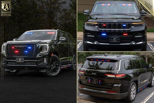 A black SUV with various emergency lights on the front grille, rear, and interior dashboard. The vehicle features red, blue, and white lights commonly used by law enforcement or emergency services.