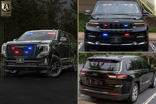 A black SUV with various emergency lights on the front grille, rear, and interior dashboard. The vehicle features red, blue, and white lights commonly used by law enforcement or emergency services.